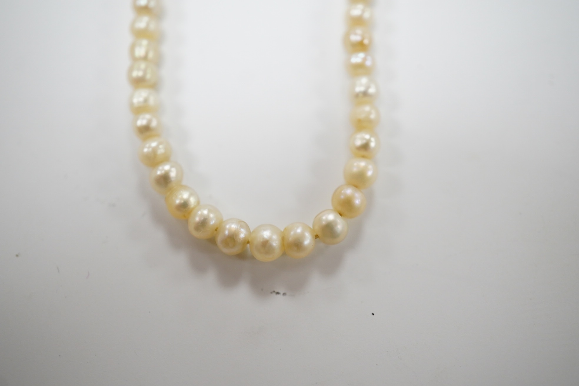 An early 20th century single strand graduated seed pearl necklace, with 9ct barrel clasp, 38cm. Condition - fair